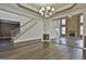 Spacious dining room with hardwood floors, chandelier and views of the Gathering room and fireplace at 12021 Scottish Ct, Fayetteville, GA 30215