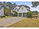 Two-story house with white exterior, landscaping, and a two-car garage at 12021 Scottish Ct, Fayetteville, GA 30215