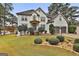 Two-story house with white exterior, landscaping, and a two-car garage at 12021 Scottish Ct, Fayetteville, GA 30215