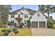 Two-story house with white exterior, landscaping, and a two-car garage at 12021 Scottish Ct, Fayetteville, GA 30215