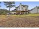 Two-story home with a deck and a view of the lake at 12021 Scottish Ct, Fayetteville, GA 30215