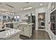 Modern kitchen with island, laundry access, and stainless steel appliances at 12021 Scottish Ct, Fayetteville, GA 30215