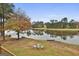 Serene lake view with trees and a canoe at 12021 Scottish Ct, Fayetteville, GA 30215