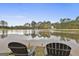 Calm lake view from the lakeside with two chairs at 12021 Scottish Ct, Fayetteville, GA 30215