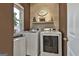 Bright laundry room with washer, dryer, and ample storage at 12021 Scottish Ct, Fayetteville, GA 30215
