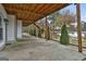Covered patio with stairs leading to the backyard and lake view at 12021 Scottish Ct, Fayetteville, GA 30215