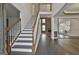 Grand two-story entry with a wooden staircase and dark hardwood floors at 12021 Scottish Ct, Fayetteville, GA 30215