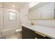 Modern bathroom with gold fixtures, white countertop, dark cabinets, and white tile shower at 79 Turner Dr, Mcdonough, GA 30252