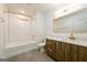 Modern bathroom with white subway tile, wood vanity, and gold fixtures at 79 Turner Dr, Mcdonough, GA 30252