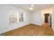 Empty bedroom with wood-look flooring, white walls, and windows with blinds at 79 Turner Dr, Mcdonough, GA 30252