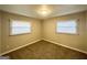 Bright bedroom with neutral walls, carpet flooring, and two windows with blinds at 2228 Sw Springdale Cir, Atlanta, GA 30315