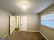 Spacious bedroom with carpeting, multiple doors, and a window with blinds at 2228 Sw Springdale Cir, Atlanta, GA 30315