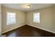 Bedroom with hardwood floors and two windows at 8406 Norris Lake Rd, Snellville, GA 30039