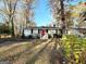 Ranch home with red door, steps, and landscaping at 8406 Norris Lake Rd, Snellville, GA 30039