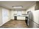 Modern kitchen with white cabinets, stainless steel appliances, and grey countertops at 8406 Norris Lake Rd, Snellville, GA 30039