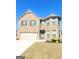 Two-story brick home with attached garage and landscaped lawn at 116 Jodi Pl, Locust Grove, GA 30248
