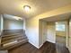 Inviting entryway with staircase, wood-look floors, and views to living room at 2910 Jerome Rd, Atlanta, GA 30349