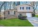 Two-story house with brick and beige siding, a two-car garage, and a well-manicured lawn at 2910 Jerome Rd, Atlanta, GA 30349