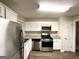 Modern kitchen with white cabinets, stainless steel appliances, and granite countertops at 2910 Jerome Rd, Atlanta, GA 30349