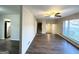 Open living area with wood-look floors, large windows, and views to kitchen and entryway at 2910 Jerome Rd, Atlanta, GA 30349