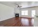 Living room with fireplace, hardwood floors, and ceiling fan at 53 Providence Oak Ct, Lawrenceville, GA 30046