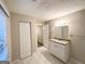 Updated bathroom with granite countertop, white vanity, and tiled floor at 1327 Sharon Nw St, Atlanta, GA 30314