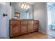 Bathroom with wood cabinets and a large vanity mirror at 145 West Honeysuckle Lane, Carrollton, GA 30116