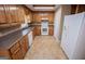 Kitchen features wood cabinets and white appliances at 145 West Honeysuckle Lane, Carrollton, GA 30116