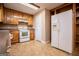 White appliances and wood cabinets feature in this kitchen at 145 West Honeysuckle Lane, Carrollton, GA 30116