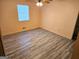 Bedroom with ceiling fan, wood-look floors, and neutral walls at 7196 Woodland Cir, Riverdale, GA 30274