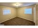 Bright bedroom with neutral carpeting and two windows at 220 Oakcliff Nw Ct, Atlanta, GA 30331