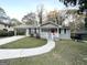 Updated ranch home features a red front door and a well-manicured lawn at 220 Oakcliff Nw Ct, Atlanta, GA 30331