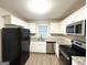 Modern kitchen with white cabinets, granite counters, and stainless steel appliances at 220 Oakcliff Nw Ct, Atlanta, GA 30331