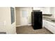 Galley kitchen with white cabinets, granite countertops and black appliances at 220 Oakcliff Nw Ct, Atlanta, GA 30331