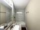 Updated bathroom with granite vanity, tiled shower, and bathtub at 3010 Pasadena Dr, Decatur, GA 30032