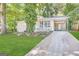 Charming ranch home with a landscaped lawn and driveway at 3010 Pasadena Dr, Decatur, GA 30032