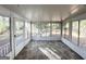 Sunroom with gray vinyl flooring and access to backyard at 3010 Pasadena Dr, Decatur, GA 30032