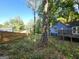 Overgrown backyard with wooded area and fence at 3149 Patuxent Trce, Lithonia, GA 30038