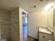 Updated bathroom with granite countertop, tiled shower, and view of adjacent room at 4982 Millstone Walk, Stone Mountain, GA 30088
