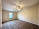 Spacious carpeted bedroom with ceiling fan and window at 4982 Millstone Walk, Stone Mountain, GA 30088