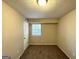 Small bedroom with window and neutral decor at 4982 Millstone Walk, Stone Mountain, GA 30088