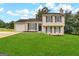Two-story house with attached garage and manicured lawn at 4982 Millstone Walk, Stone Mountain, GA 30088