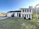 Tan two-story house featuring a garage and well-maintained lawn at 4982 Millstone Walk, Stone Mountain, GA 30088