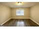 Spacious bedroom with wood-look floors and a large window at 55 Stone Creek Dr, Covington, GA 30016