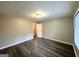 Well-lit bedroom with wood-like flooring and access to a bathroom at 55 Stone Creek Dr, Covington, GA 30016