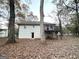 Back of house with deck and wooded backyard at 55 Stone Creek Dr, Covington, GA 30016