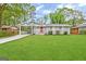 Charming ranch home with a red door, covered porch, and well-maintained lawn at 2057 Sombrero Se Way, Atlanta, GA 30316