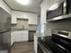 Modern kitchen with white cabinets, granite countertops, and stainless steel appliances at 2057 Sombrero Se Way, Atlanta, GA 30316