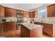 Well-equipped kitchen with wooden cabinets, granite countertops, and stainless steel appliances at 1390 Turtle Dove Ln, Lawrenceville, GA 30043