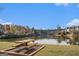 Community lake with picnic table and fall foliage at 1390 Turtle Dove Ln, Lawrenceville, GA 30043